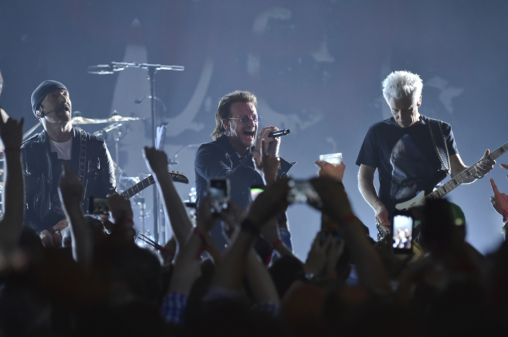 The Edge, from left, Bono and Adam Clayton of U2 perform