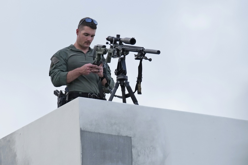 Precautions here in America as well: A police sniper waits for the start of a rally in support of Israel, at the Holocaust Memorial Miami Beach, Tuesday