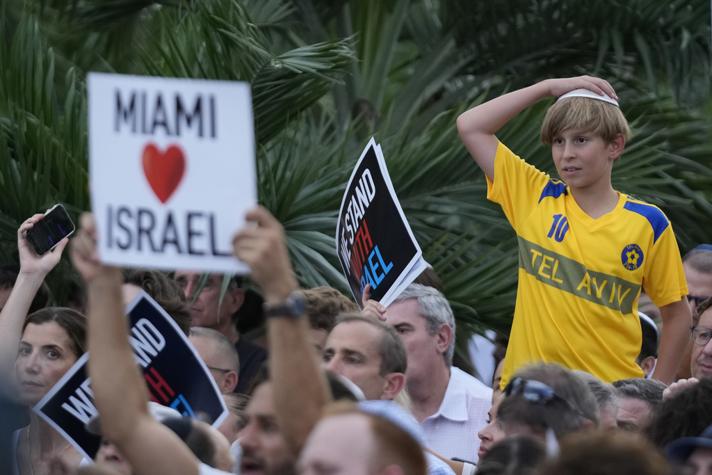 A young boy looks on as he attends a rally in support of Israel, at the Holocaust Memorial Miami Beach