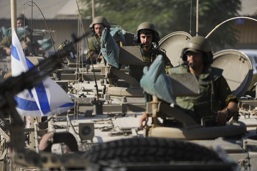 Israeli soldiers gather in a staging area near the border with Gaza Strip