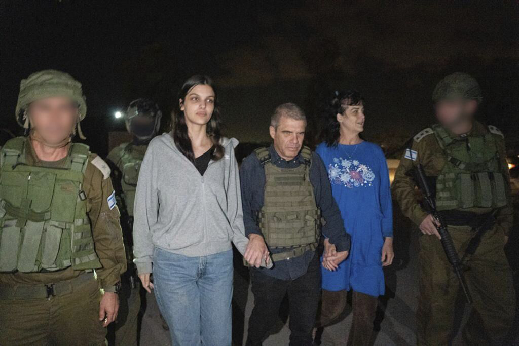 Judith Raanan, right, and her 17-year-old daughter Natalie are escorted by Israeli soldiers and Gal Hirsch, Prime Minister Benjamin Netanyahu