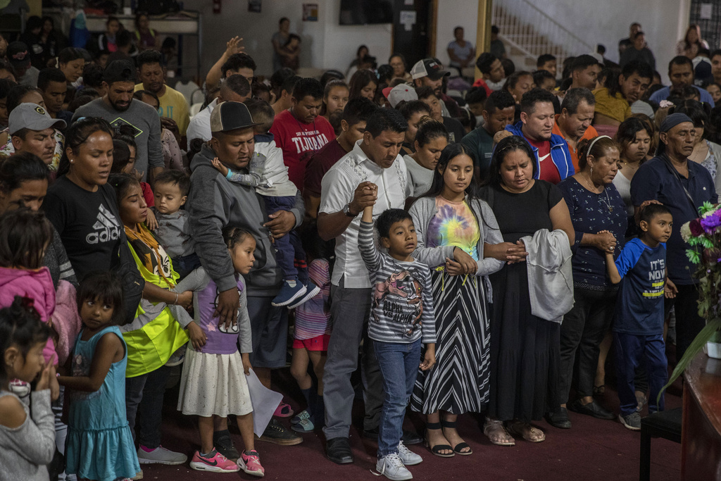 Mexican migrants, many from Michoacan state, attend a religious service at the "Embajadores de Jesus" Christian migrant shelter in Tijuana