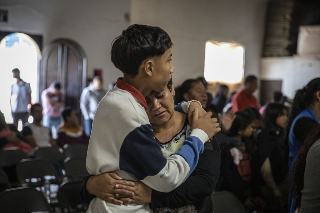 Mexican migrants, many from Michoacan state, attend a religious service at the "Embajadores de Jesus" Christian migrant shelter in Tijuana