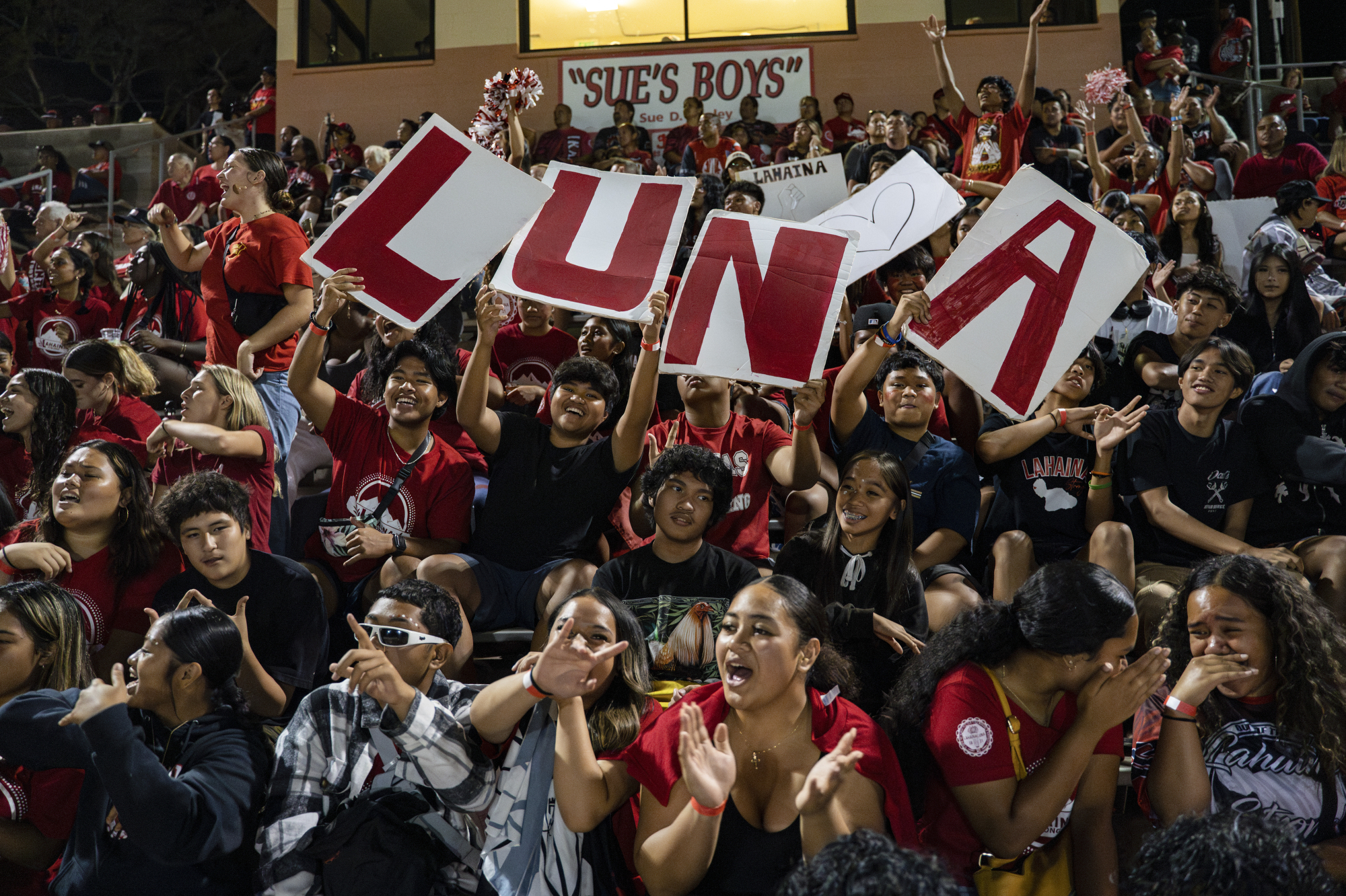 Lahainaluna High School students cheer for the varsity football team during their homecoming game at Sue D. Cooley Stadium, Saturday, Oct. 21, 2023, in Lahaina, Hawaii.