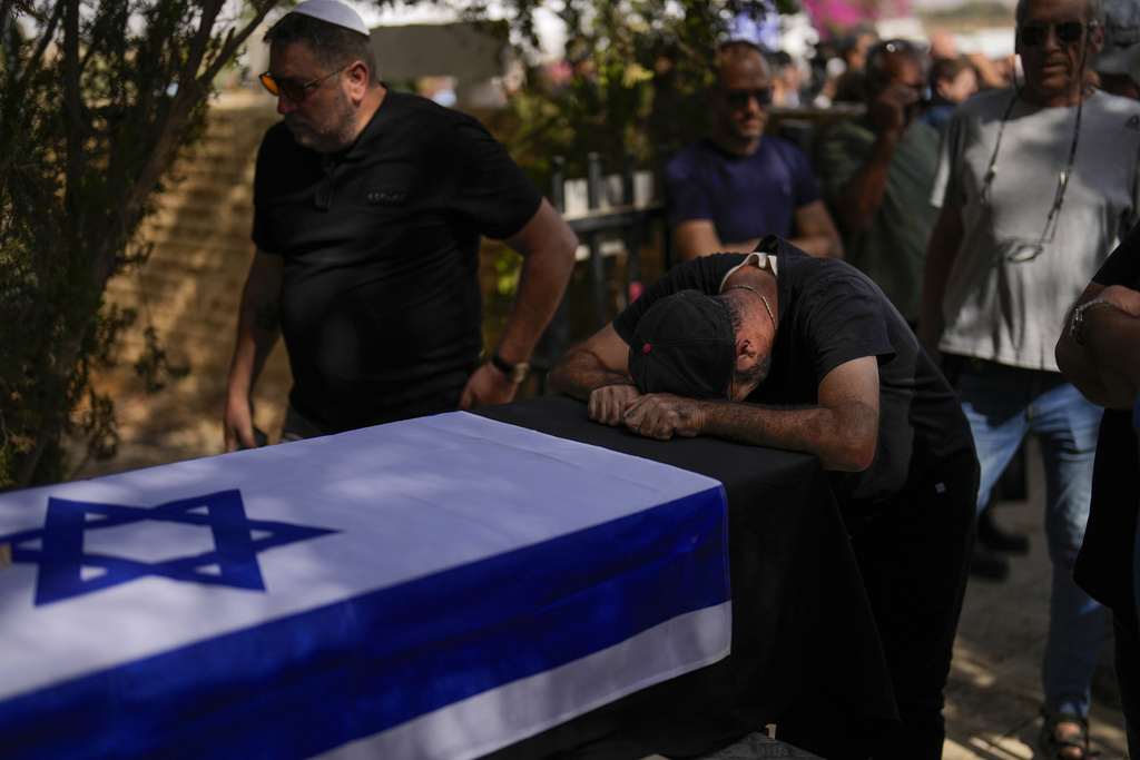 A man mourns during the funeral of Ronny Levi at Kibbutz Revivim, southern Israel