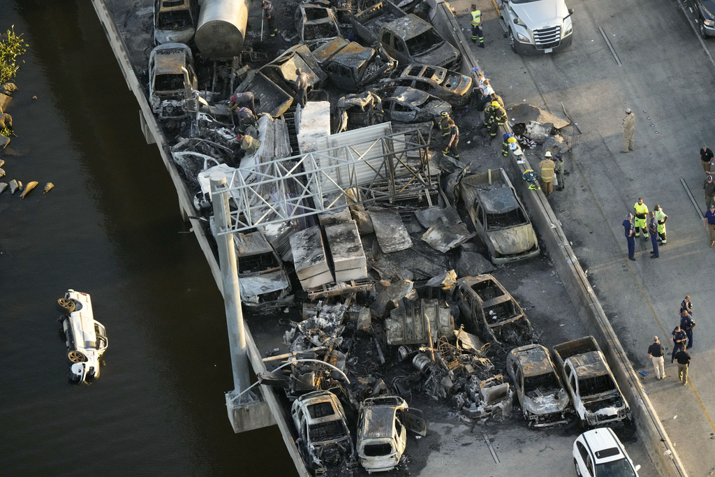 Responders are seen near wreckage in the aftermath of a multi-vehicle pileup on I-55 in Manchac, La.