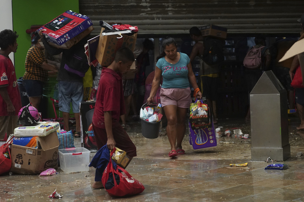 People loot a grocery store after Hurricane Otis ripped through Acapulco