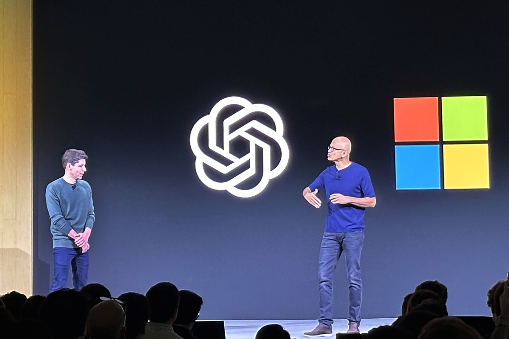 Sam Altman, left, CEO of OpenAI, appears onstage with Microsoft CEO Satya Nadella at OpenAI DevDay, OpenAI