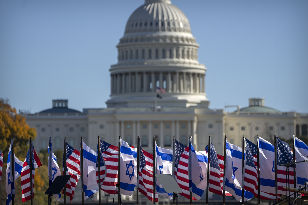 U.S. and Israeli flags fly on the stage in front of the Capitol at the March for Israel at the National Mall 