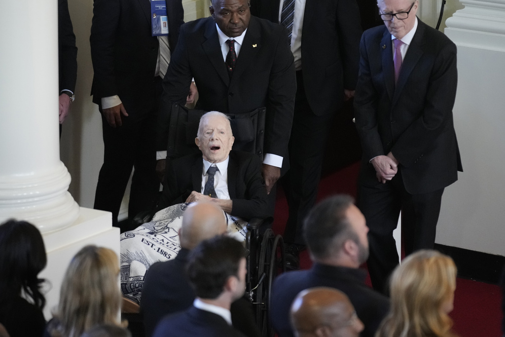 Former President Jimmy Carter, arrives to attend a tribute service for his wife