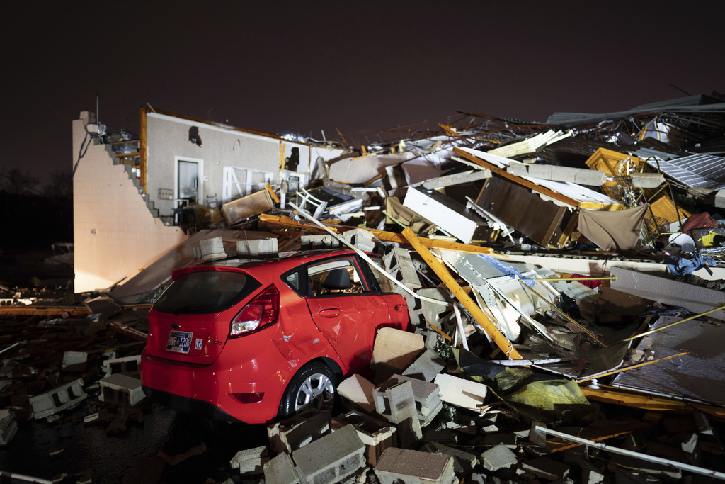 A car is buried under rubble on Main Street after a tornado hit Hendersonville, Tenn.