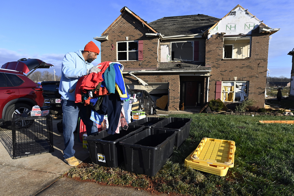 David Rogers gathers clothes from his damaged home in the West Creek Farms neighborhood, Clarksville, Tenn.