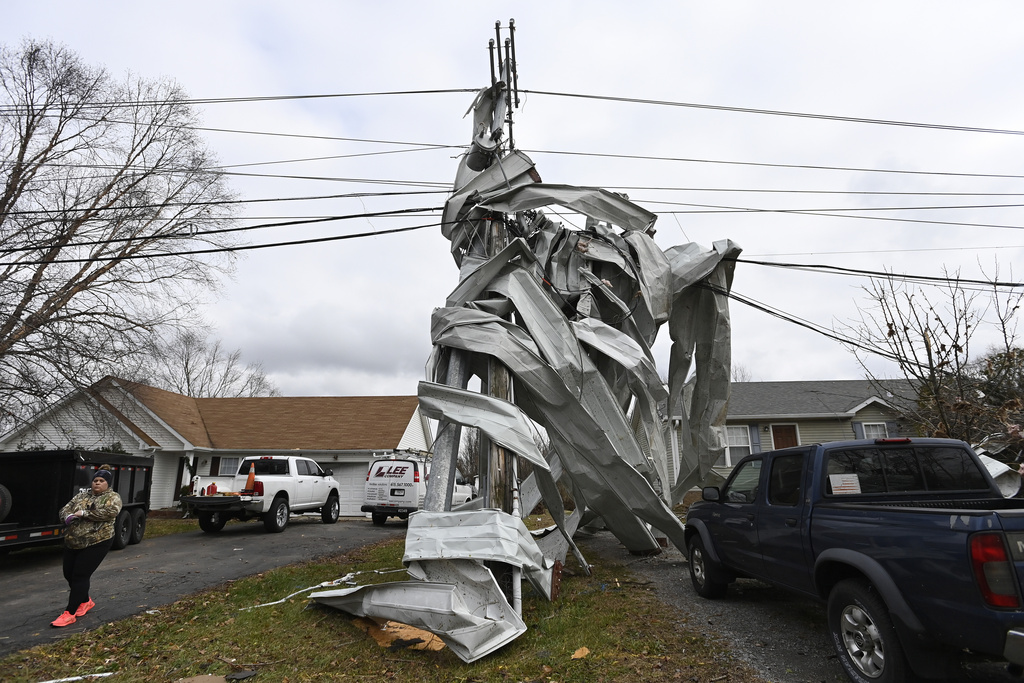 Metal roofing from a nearby church is wrapped around a utility pole in Clarksville, Tenn.