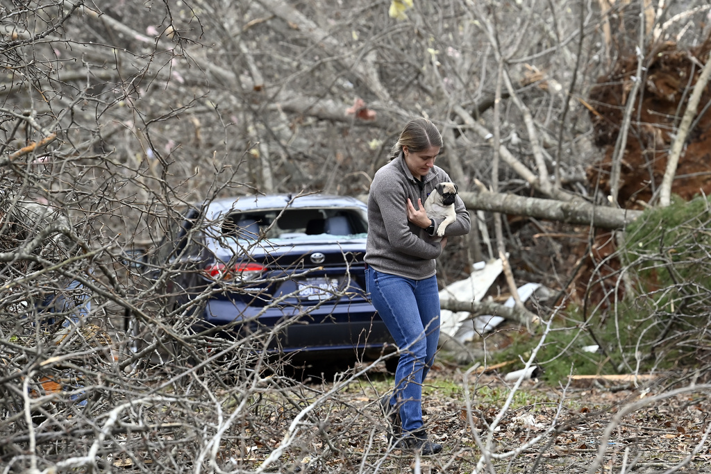 Andrea Remberger returns a lost dog to its owner in Clarksville, Tenn. Tornados caused catastrophic damage in Middle Tennessee on Saturday afternoon and evening,