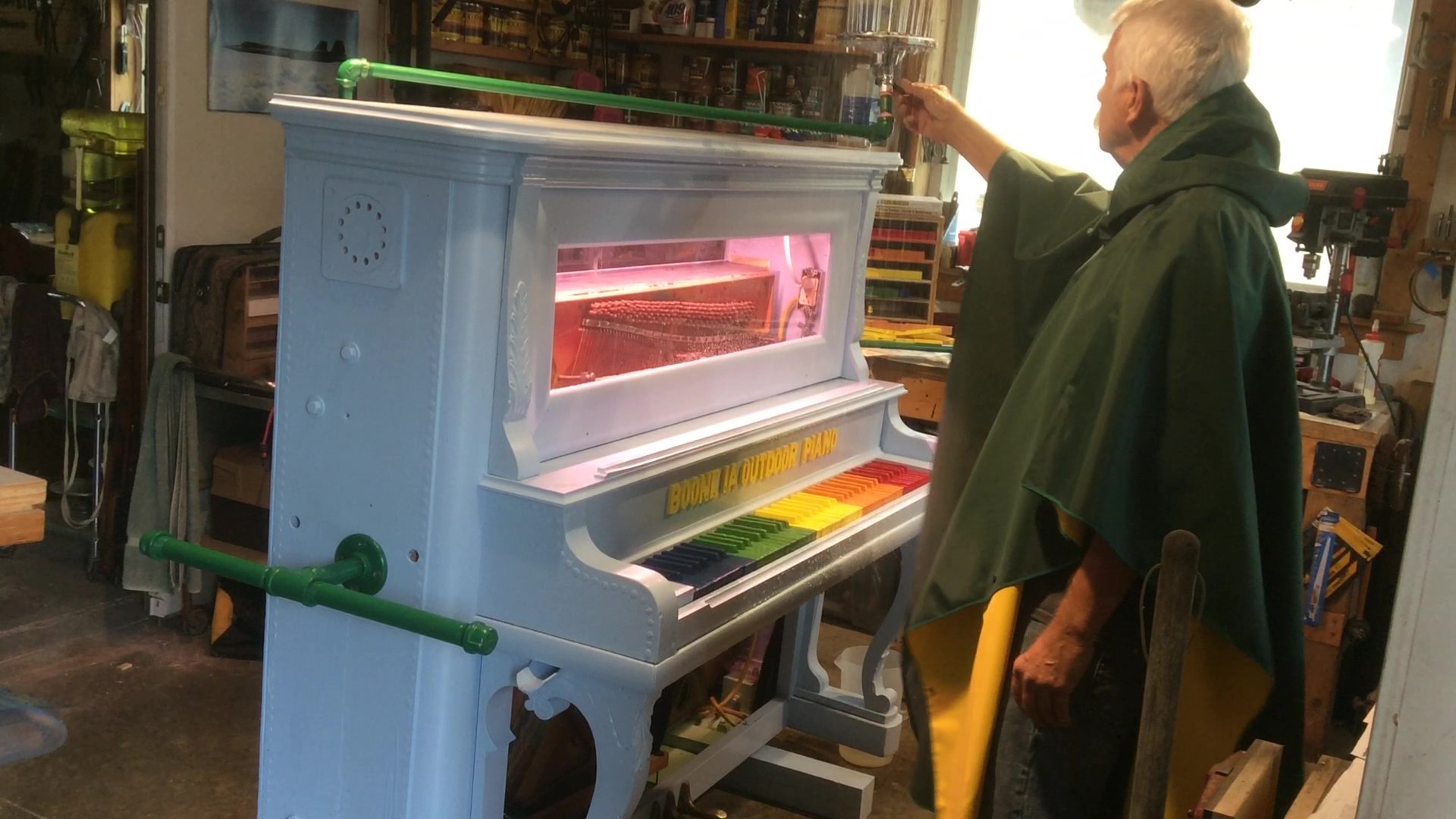 Chuck Behm turning on installed shower head to test piano in the rain