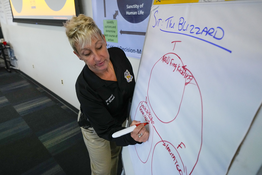 Baltimore Police Department Sgt. Amy Strand leads a professional development class with members of the police department