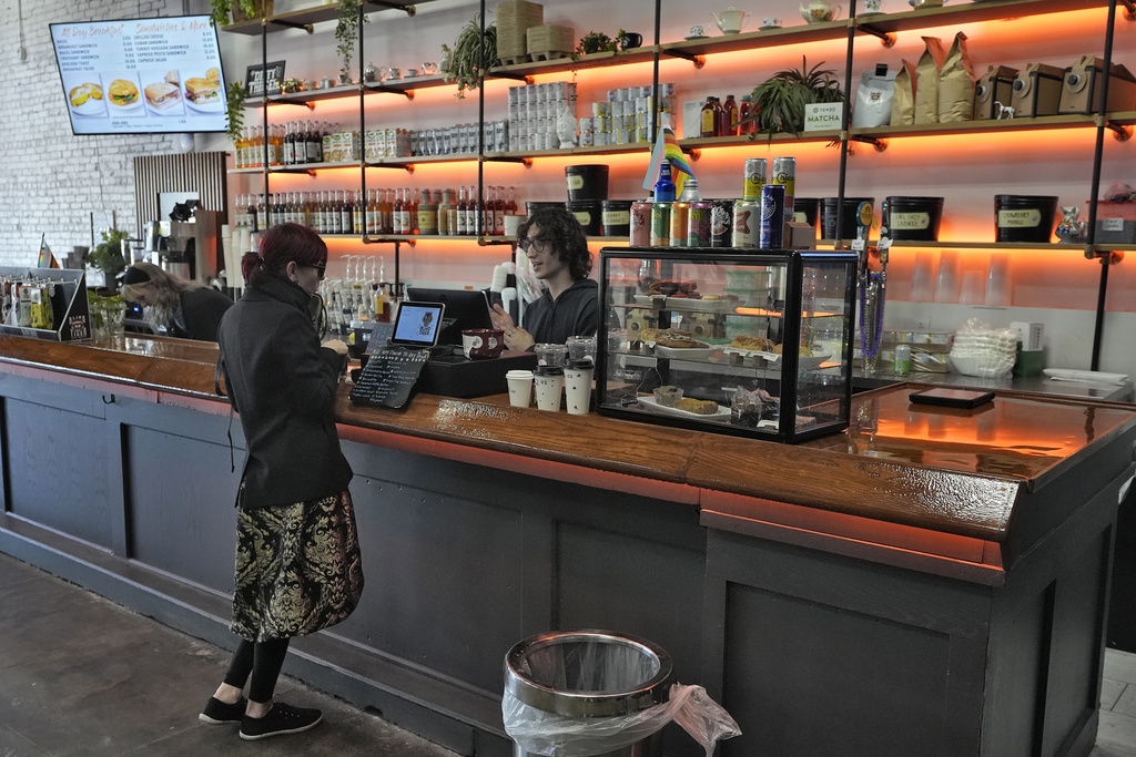 Customer buys a cup of coffee at the Blind Tiger Cafe in Tampa