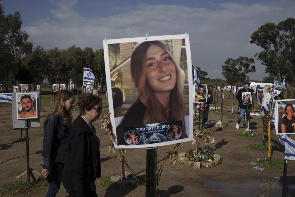 People visit the site where revelers were killed on Oct. 7 in a cross-border attack by Hamas at the Nova music festival in Re