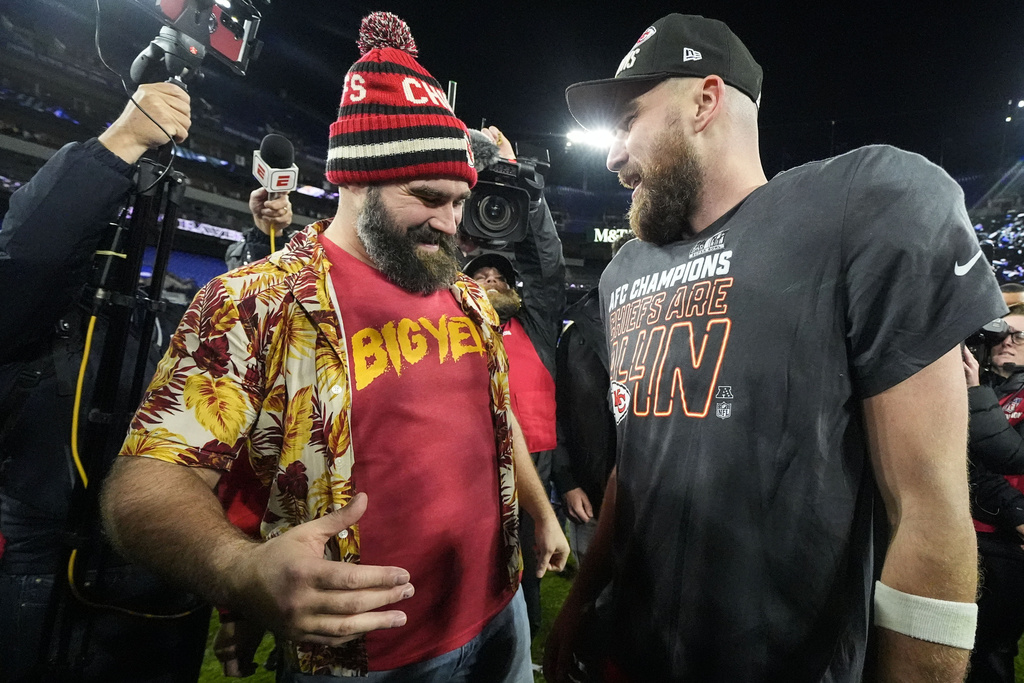 NFL player Jason Kelce, left, speaks with his brother Kansas City Chiefs tight end Travis Kelce after an AFC Championship NFL football game against the Baltimore Ravens