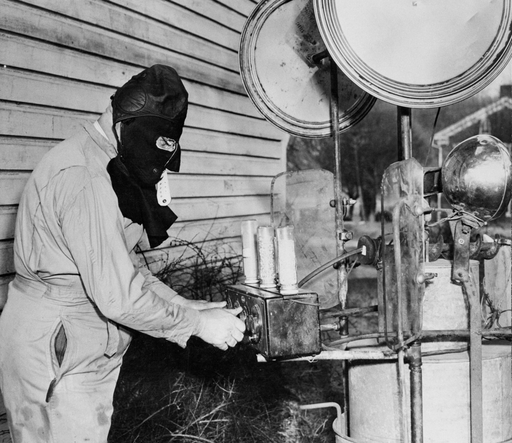 Chairman C.F. Hess, of the Hibernating Groundhog Lodge, dons a black hood as he tunes up what he says is an "ultra super-duper" invention, Jan. 31, 1947, in Quarryville, Pa. The invention would be used by lodge members to contact 10,672 registered groundhogs at their weather forecasting holes.