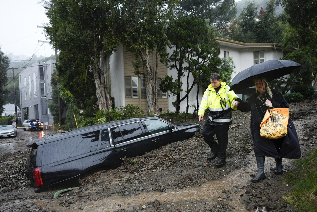 First responder helps resident evacuate from neighborhood after mudslide