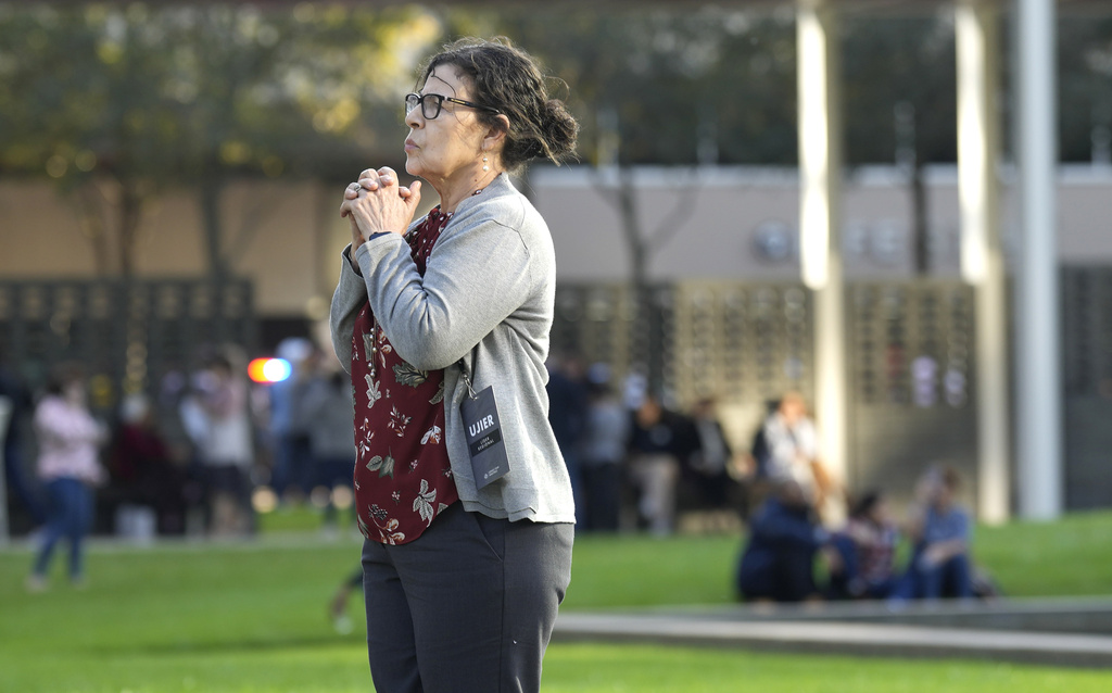 A woman prays outside Lakewood Church
