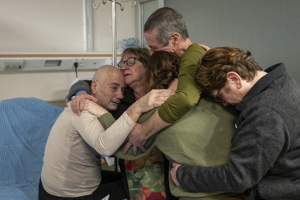 Hostage Luis Har, left, is hugged by relatives after being rescued from captivity in the Gaza Strip, at the Sheba Medical Center in Ramat Gan, Israel