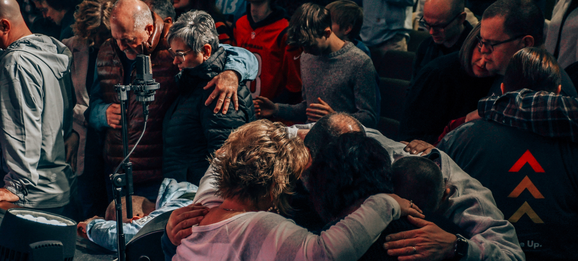 People praying, huddled together