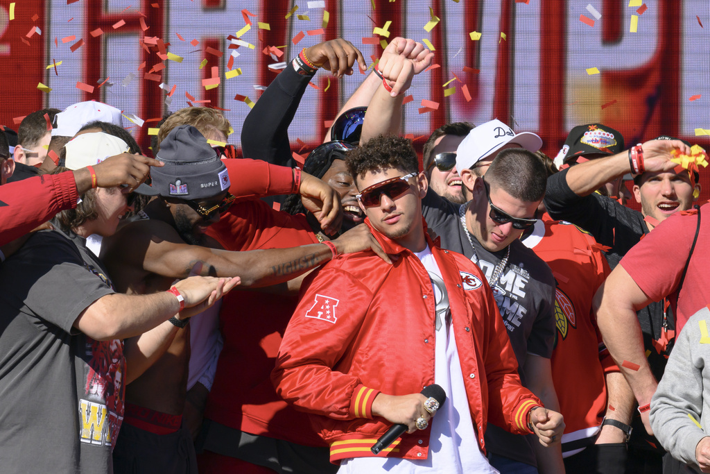 Kansas City Chiefs quarterback Patrick Mahomes is mobbed by his teammates during their victory rally in Kansas City