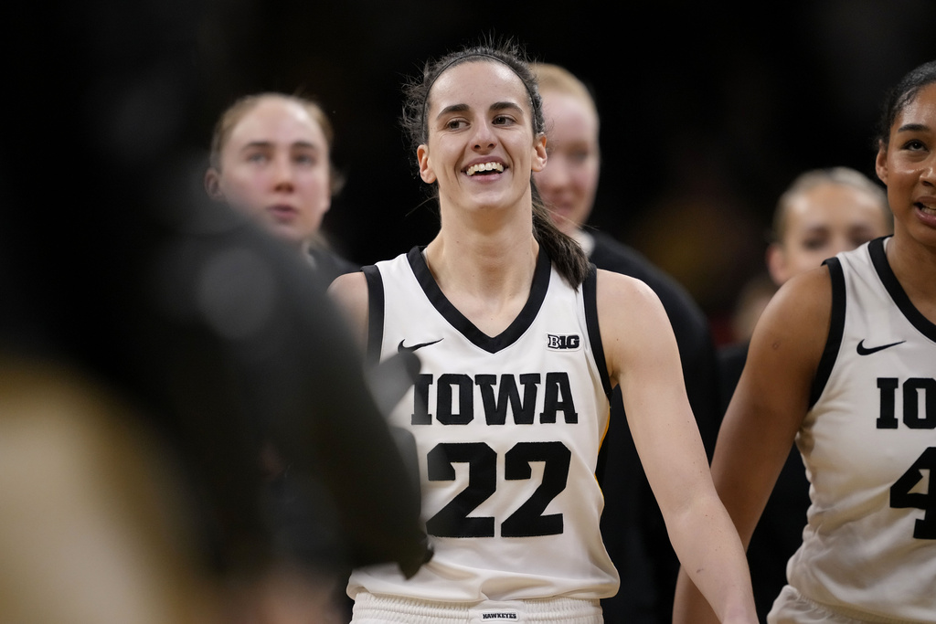 Iowa guard Caitlin Clark (22) heads to the bench for a timeout after breaking the NCAA women