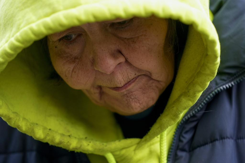 Rachel Cooper, 70, looks down as she talks about how she came to live at a longstanding homeless encampment near Walmart in Bellingham, Wash. Cooper says she has used fentanyl, which she was first introduced to by her children. 