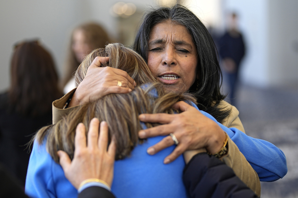 Churchgoers pray in the lobby of Lakewood Church