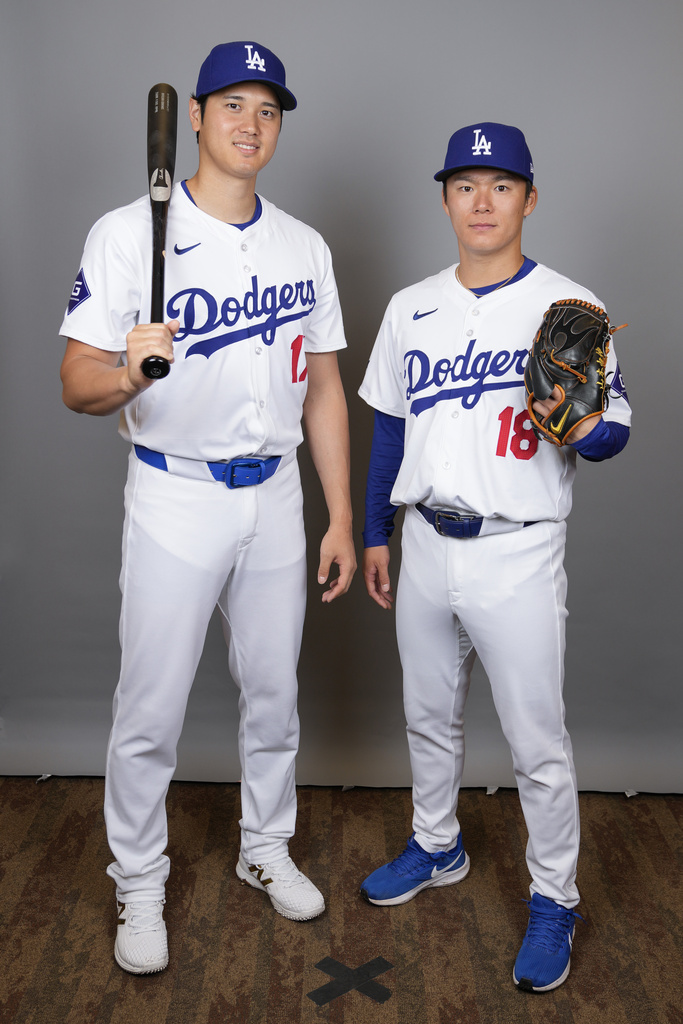 Los Angeles Dodgers designated hitter Shohei Ohtani, left, and starting pitcher Yoshinobu Yamamoto pose for a photo