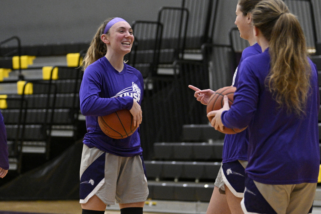 University Health Sciences and Pharmacy guard Grace Beyer laughs with teammates