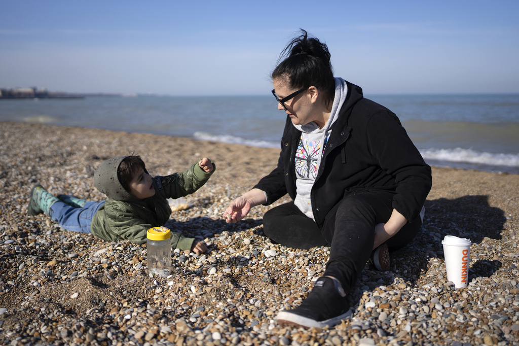 Heather Mezzacapo and her five-year-old son Giuseppe comb Loyola Beach for treasures on an unseasonably warm day in Chicago