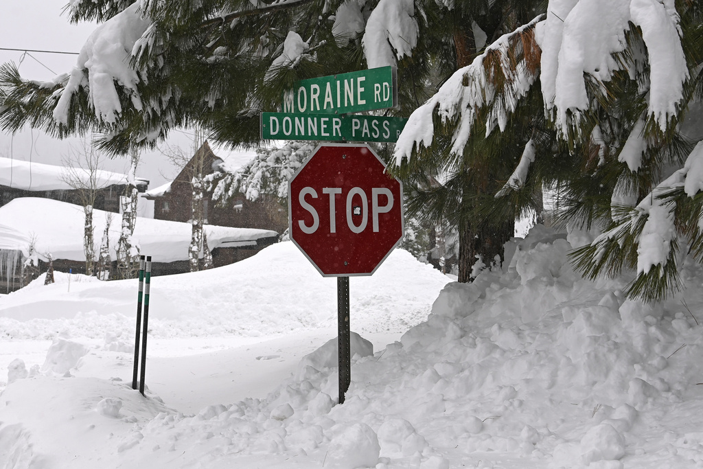 A stop sign is half buried in snow in a Donner Lake neighborhood