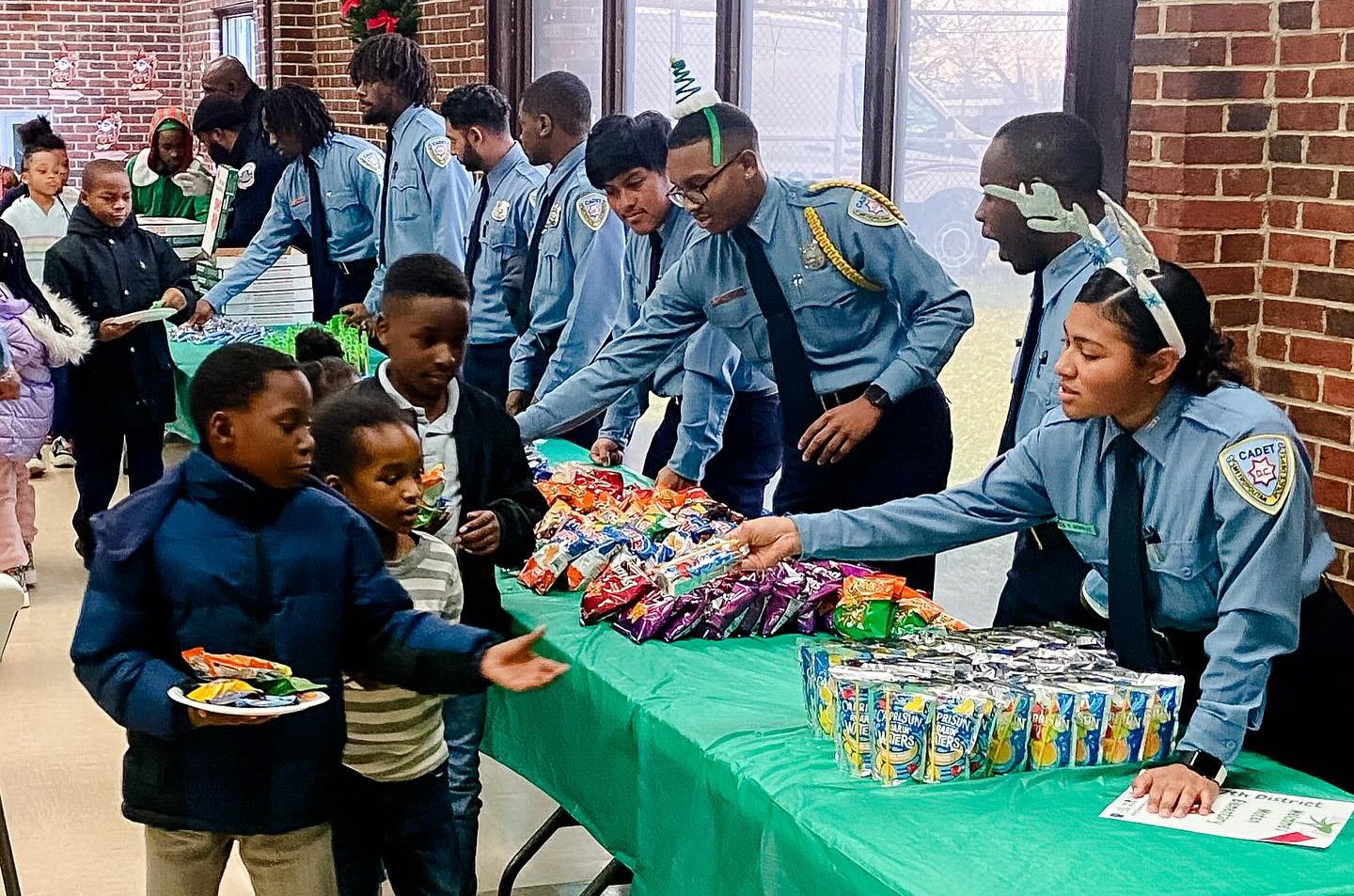 Police officers in uniform handing out snacks to kids