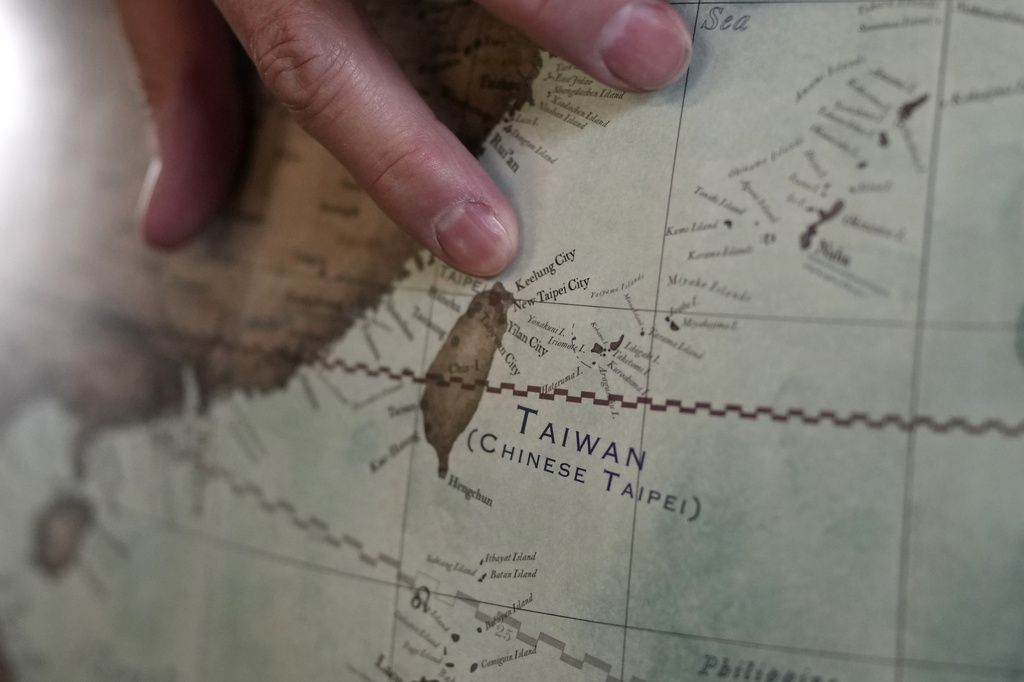 Peter Bellerby, the founder of Bellerby & Co. Globemakers, points to a map of Taiwan at a studio in London