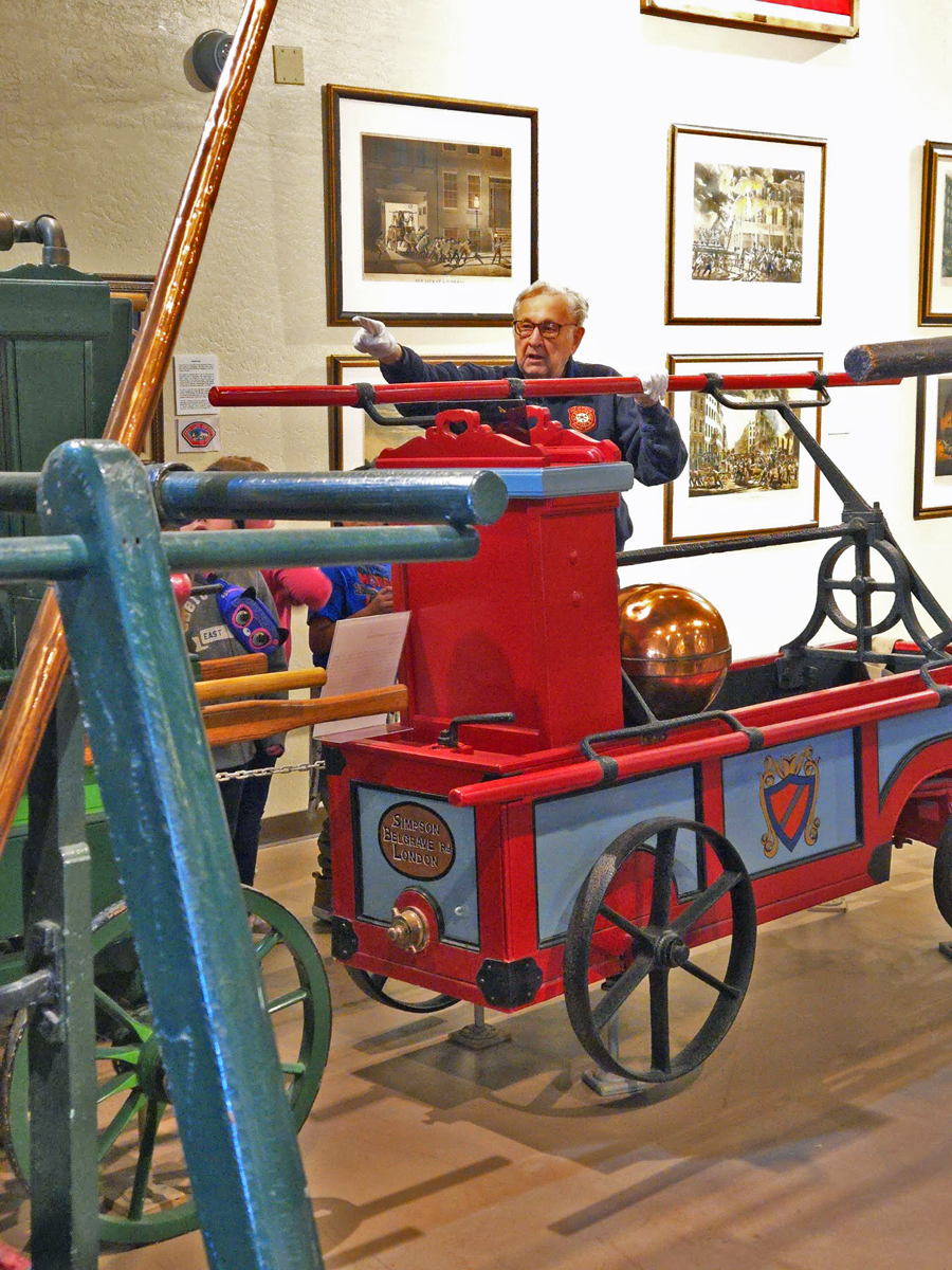 Gary Bohling demonstrating antique fire fighting equipment