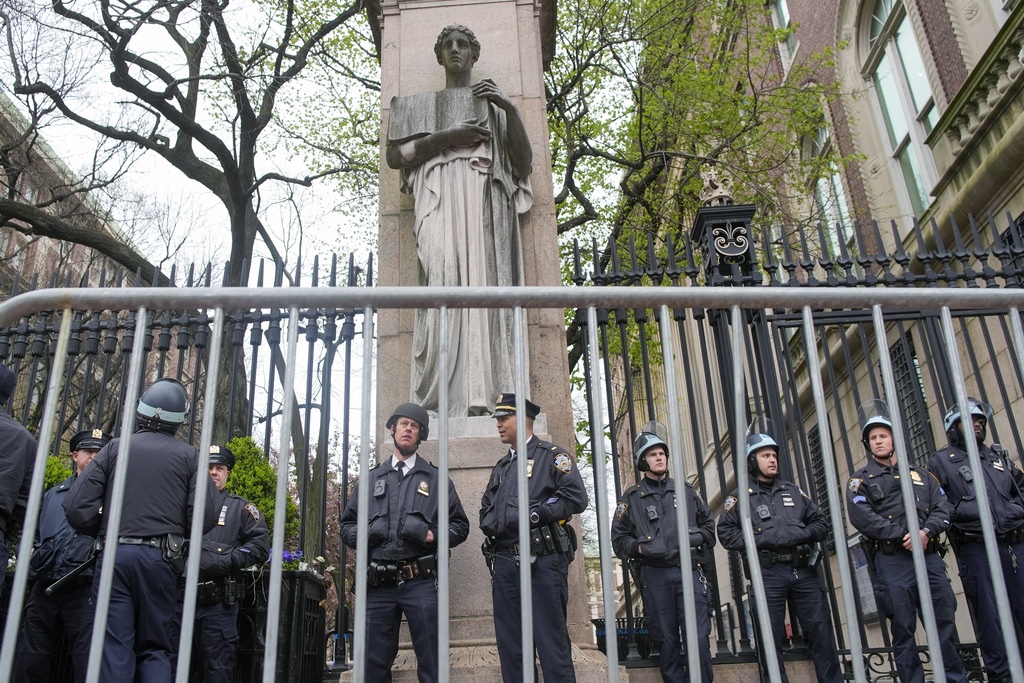 New York City police in riot gear stand guard outside the Columbia University campus after clearing the campus of protesters