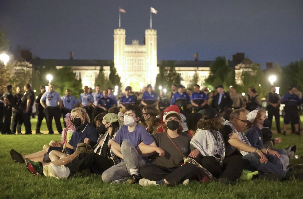 Protesters in support of Palestinians link arms as police prepare to arrest them on Washington University