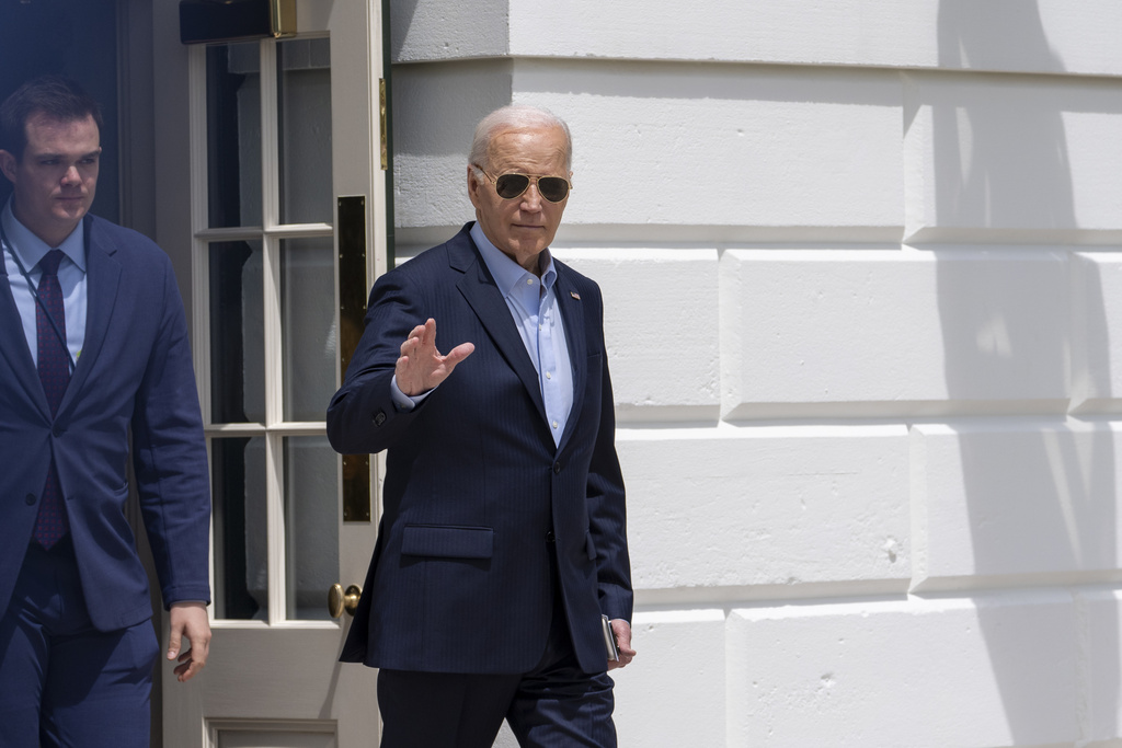 President Joe Biden waves as he walks to Marine One 