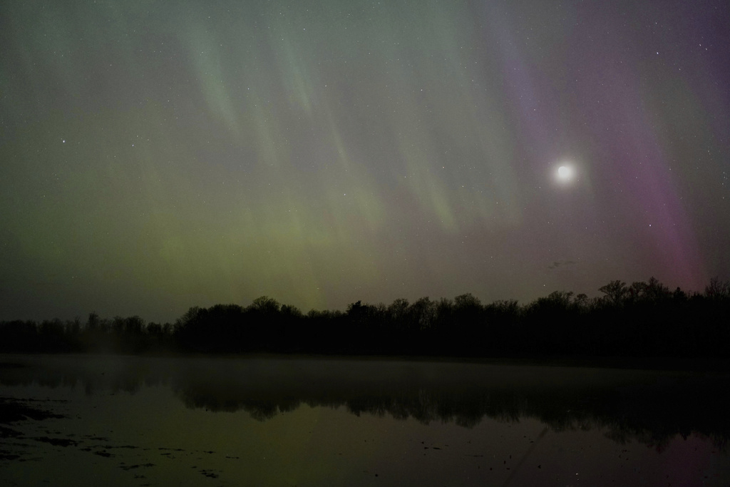The northern lights glow in the sky over St. Croix State Forest near Markville, Minn.