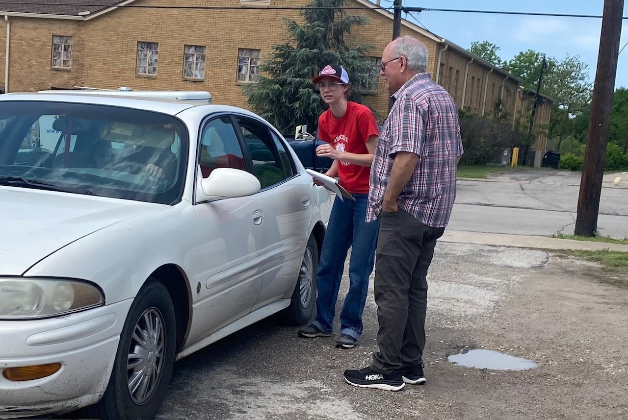 Danny Stewart and a volunteer talking to a tornado victim