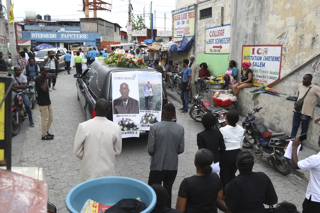 A funeral procession for mission director Judes Montis, killed by gangs alongside two of his U.S. missionary members, makes its way to the cemetery after his funeral ceremony in Port-au-Prince, Haiti