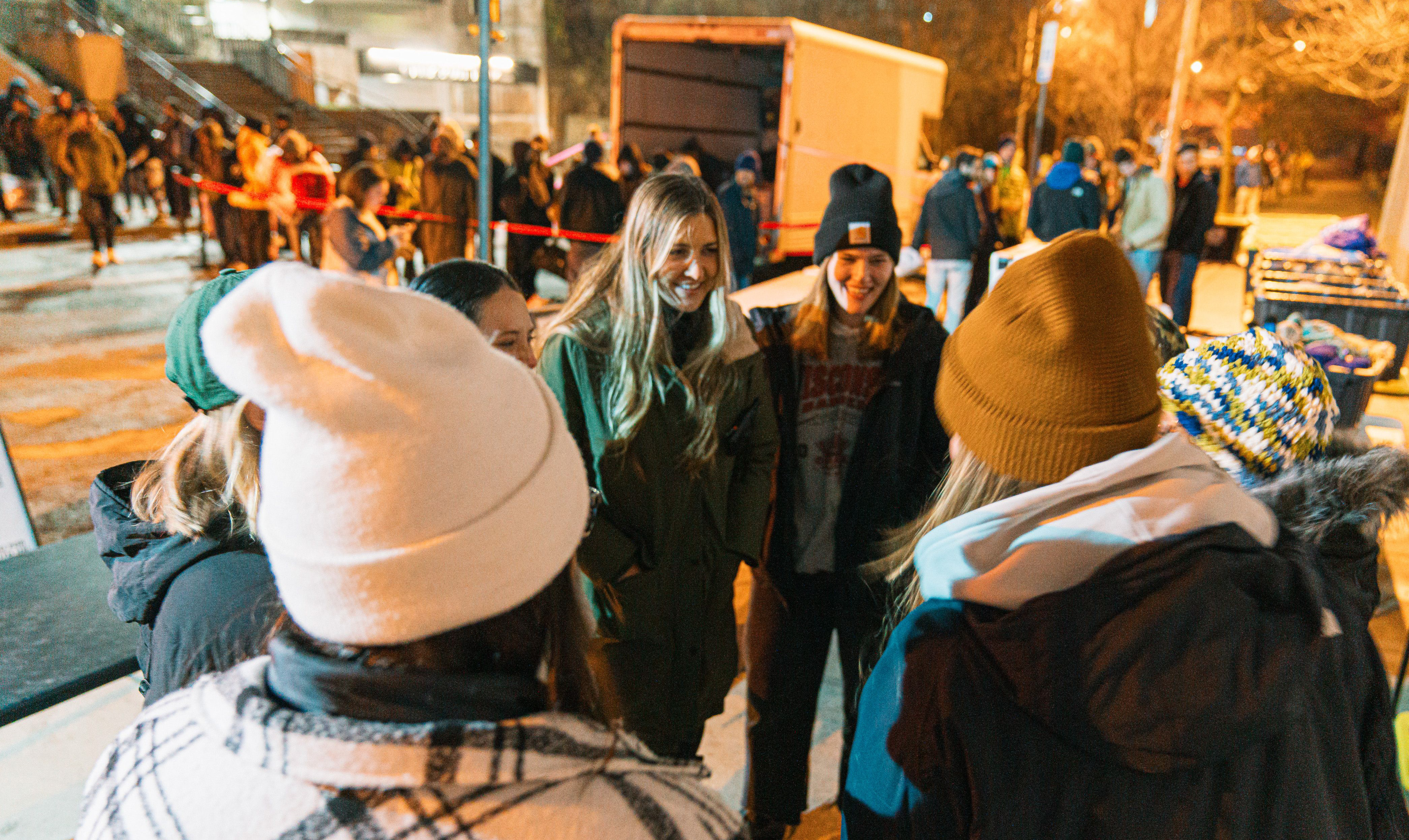 Group of people in the foreground, line of people in the background