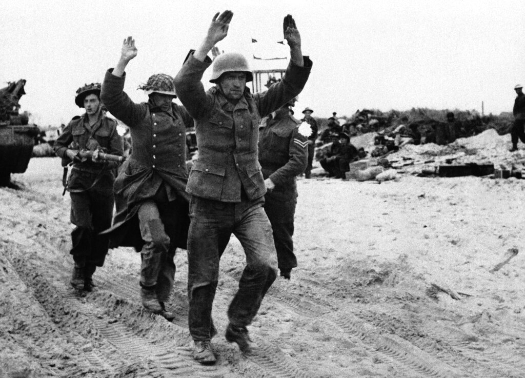 German prisoners being marched along beach on June 11, 1944