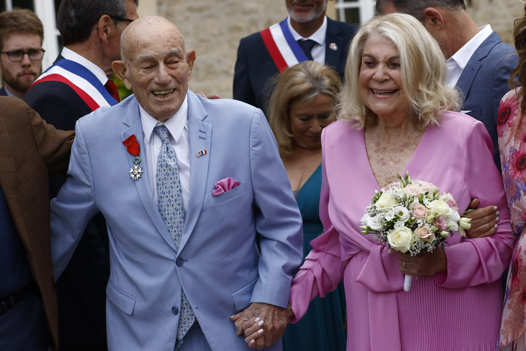 US WWII veteran Harold Terens, 100, left, and Jeanne Swerlin, 96, arrive to celebrate their wedding at the town hall of Carentan-les-Marais, in Normandy