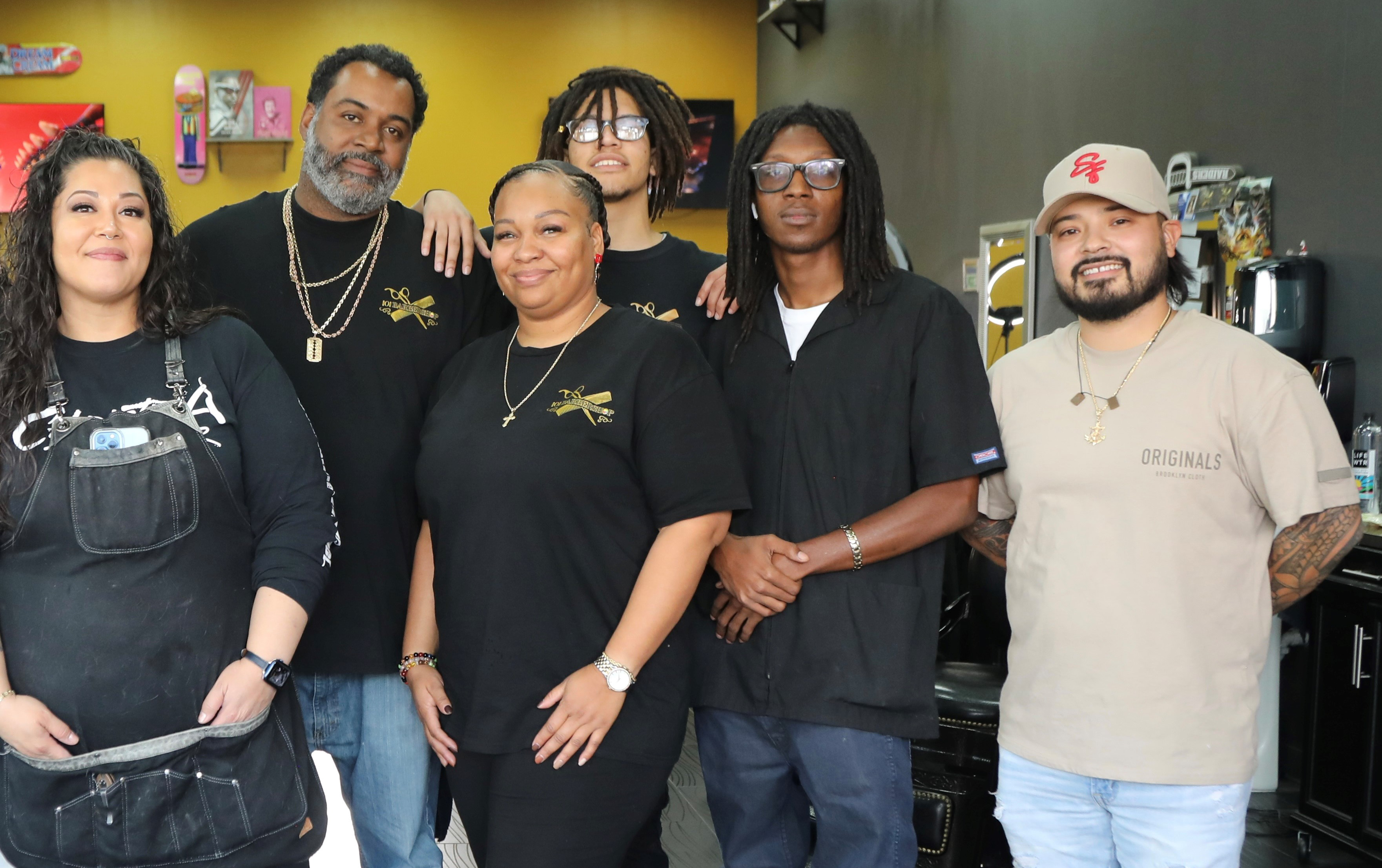 Two women, four men at barbershop