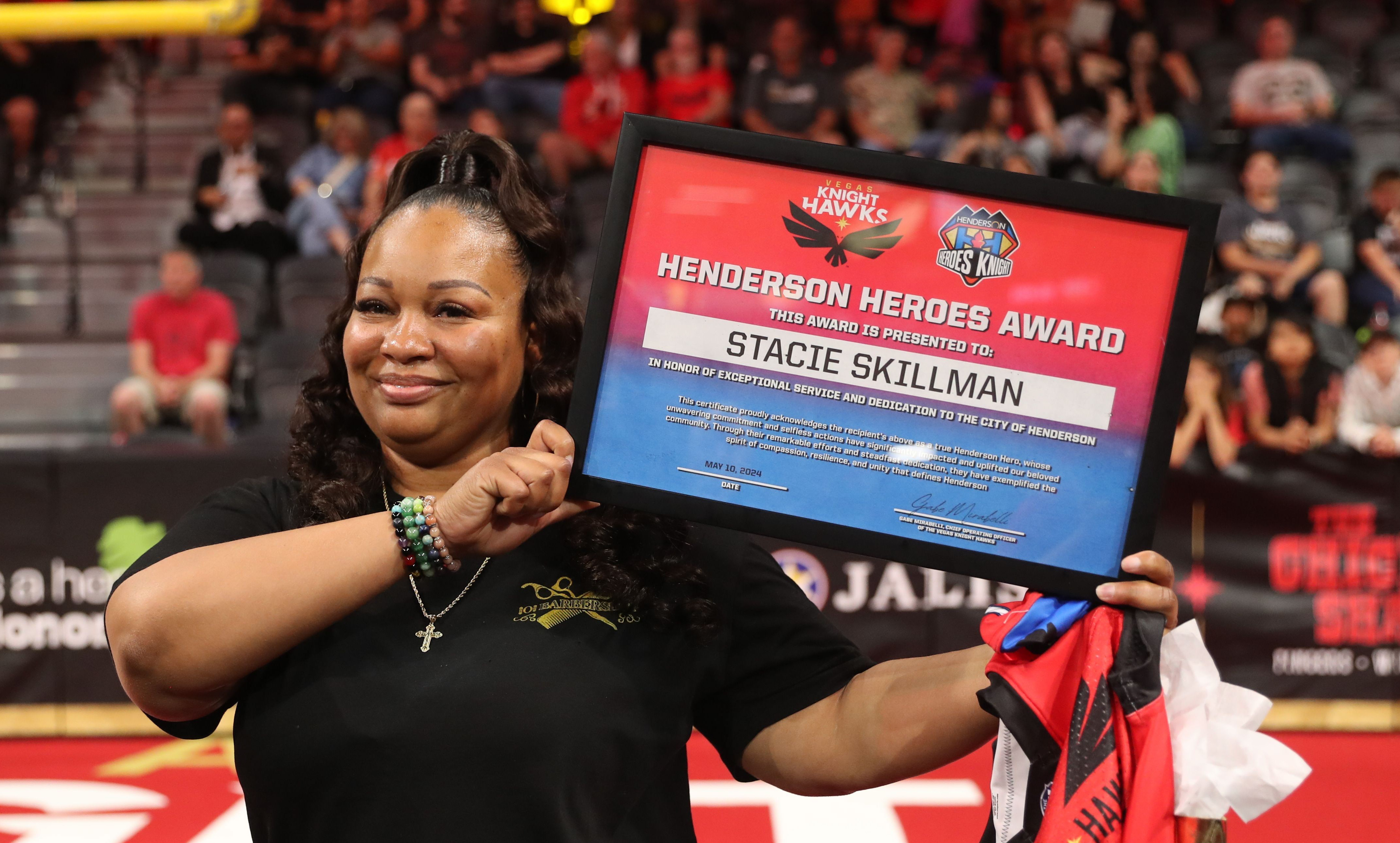 Woman holding Henderson Heroes Award